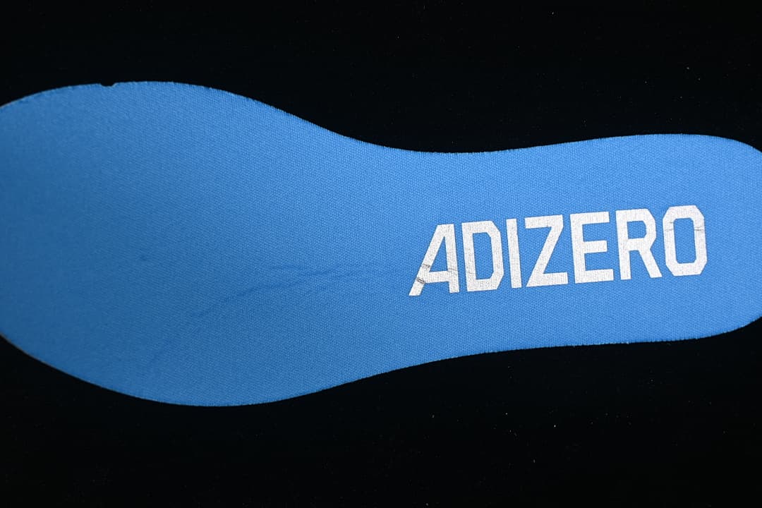 Blue insole with Adizero lettering.