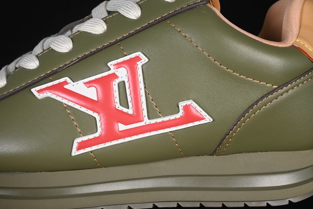 Close-up of the red-and-white side emblem, olive upper, stitching, and outsole