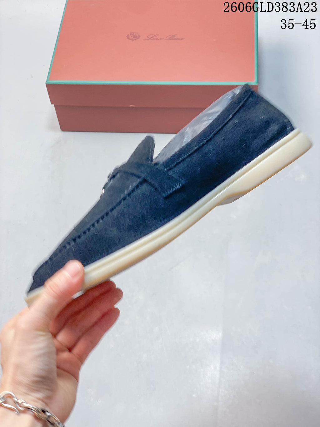 Side profile of a navy loafer with a light-colored sole