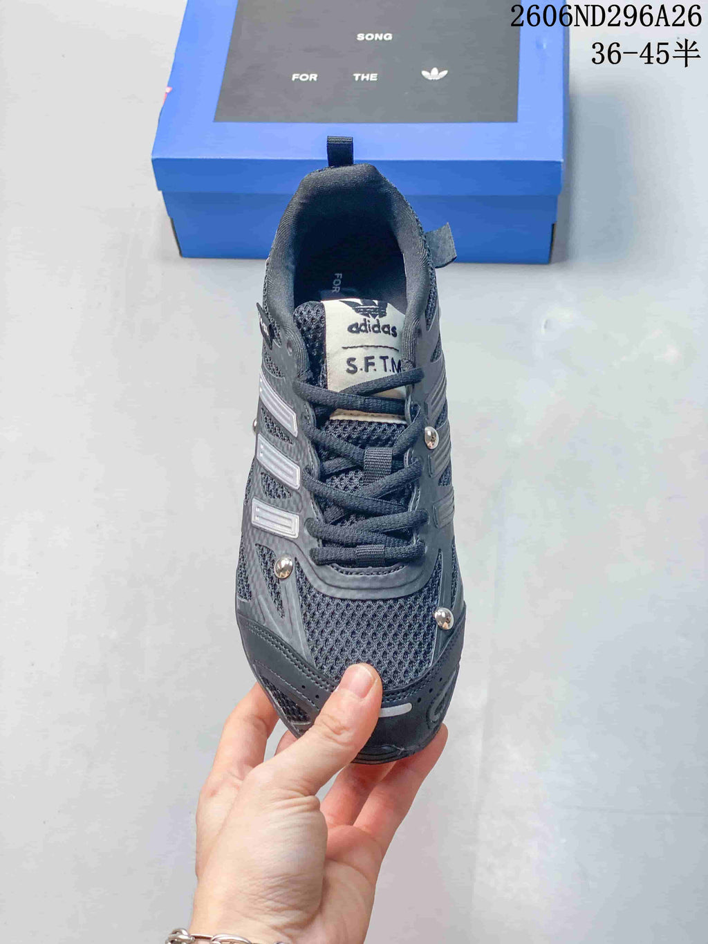 Front view of a dark gray lace-up sneaker with mesh panels