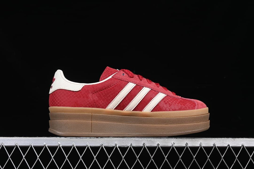 Side profile showing the red patterned upper, white stripes and platform sole