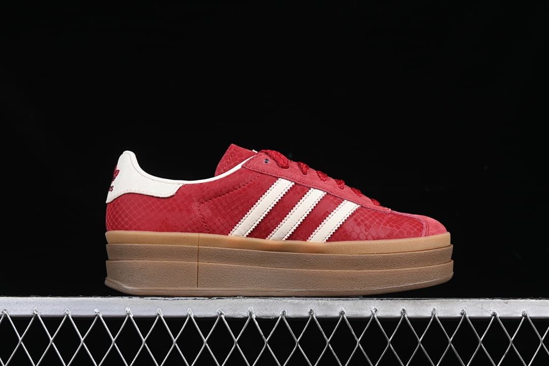 Side profile showing the red patterned upper, white stripes and platform sole