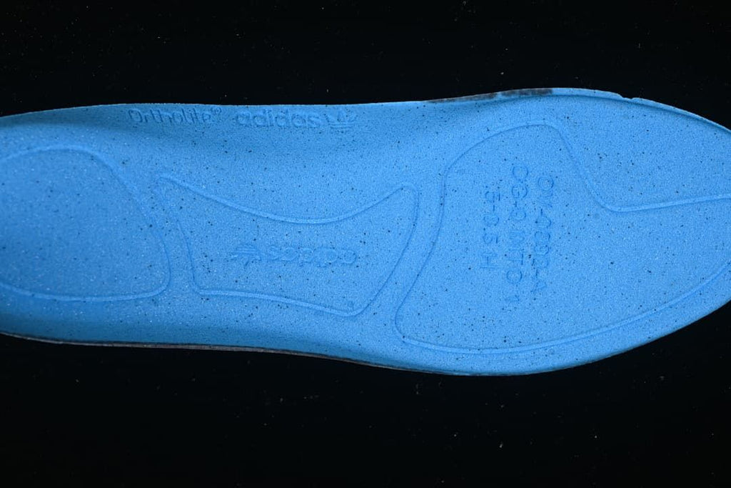 Close-up of the blue shoe insole with embossed branding
