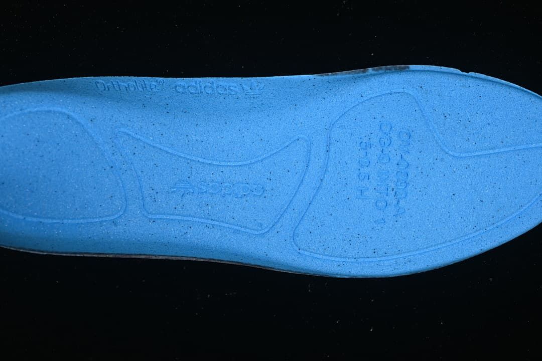 Close-up of the blue shoe insole with embossed branding