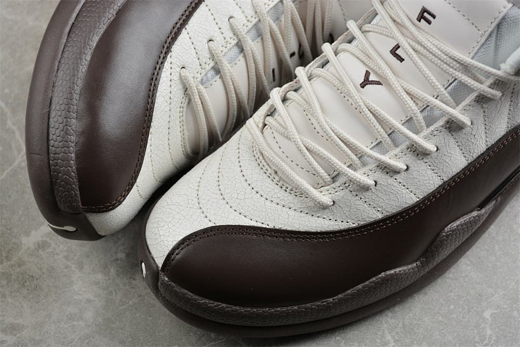 Close-up of the stitched upper, laces, and dark brown side panel