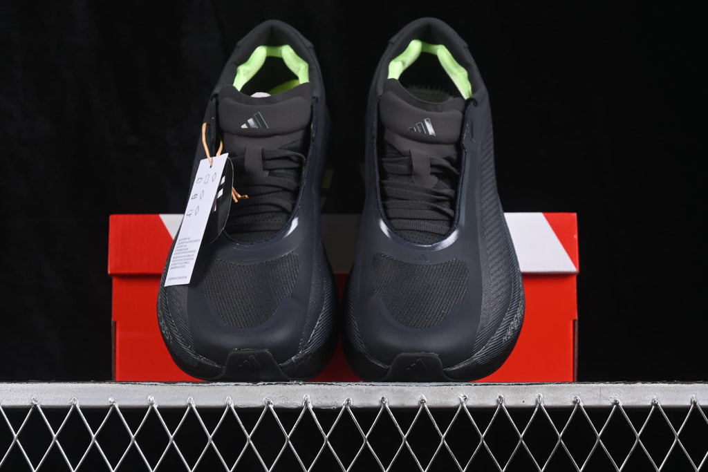 Front view of the pair with black laces, textured toe panels, and bright green lining.