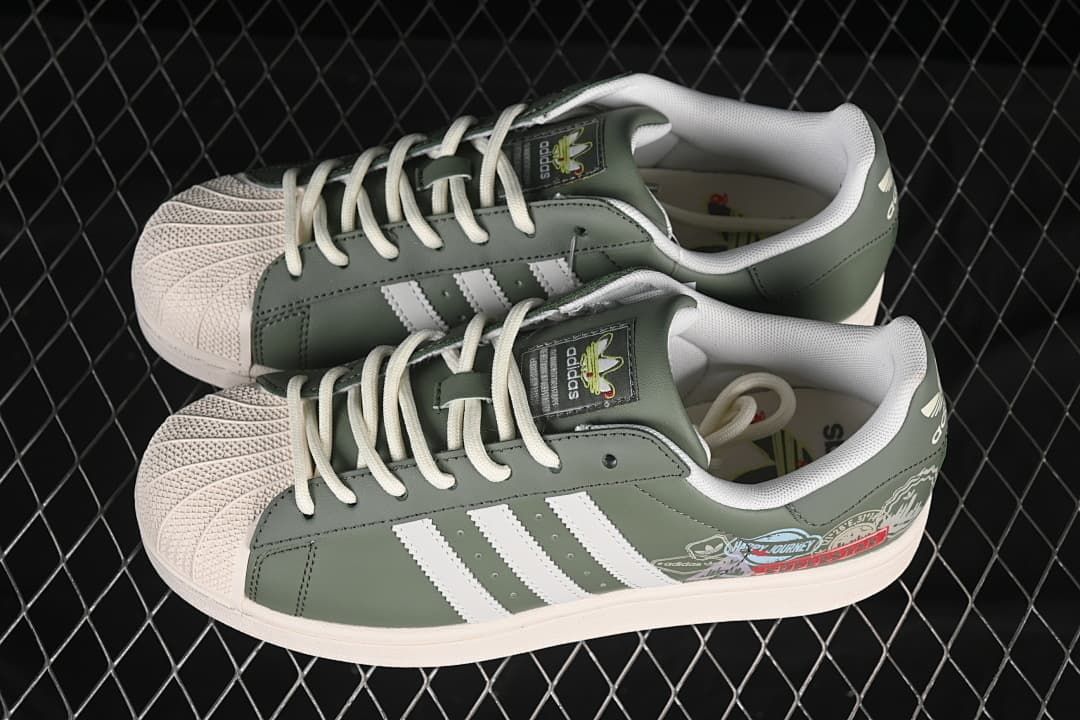 Pair of green adidas Superstar II sneakers with cream shell toes and white stripes.