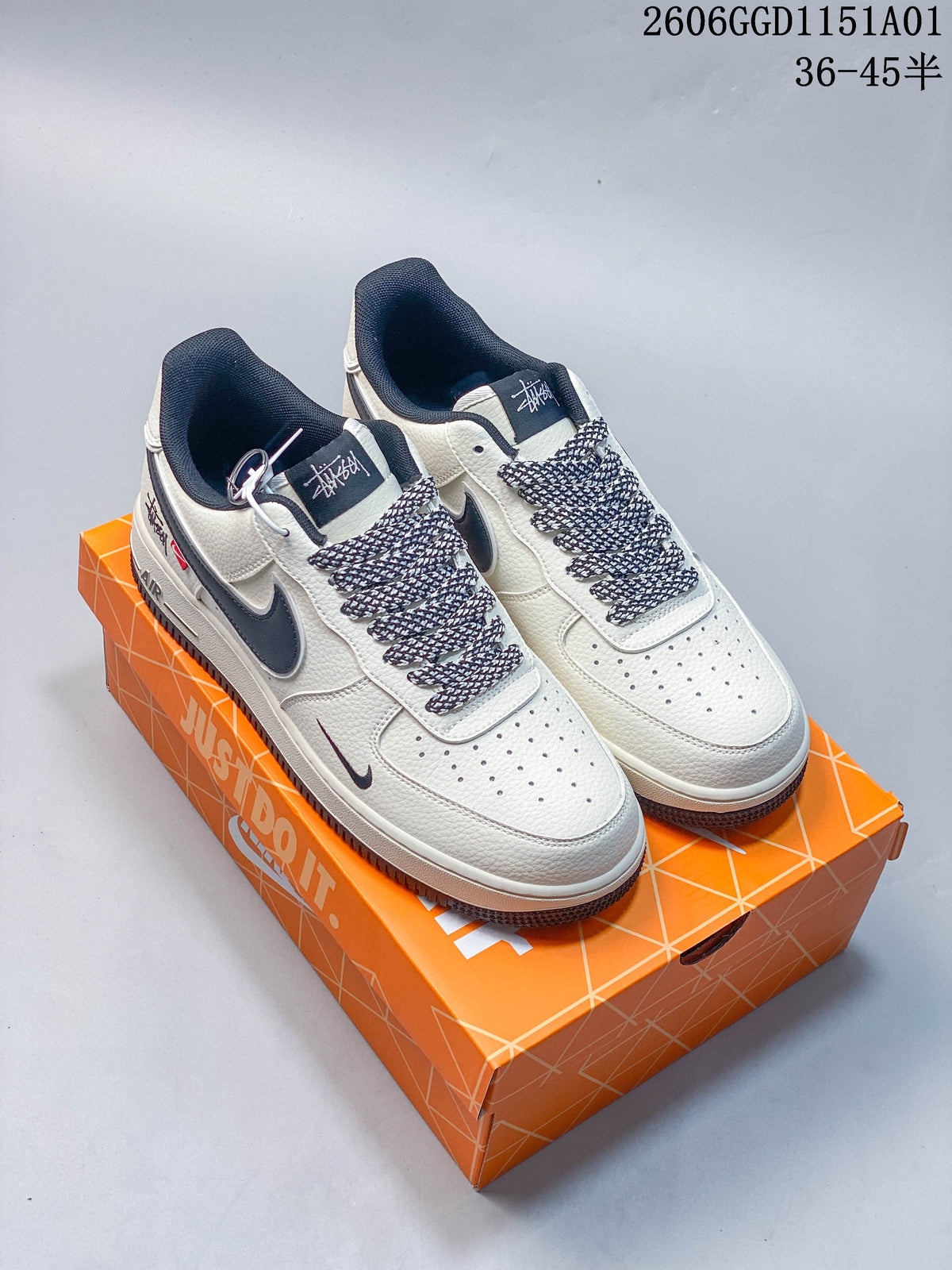 White and dark Nike Air Force 1 '07 LV8 sneakers on an orange Nike box