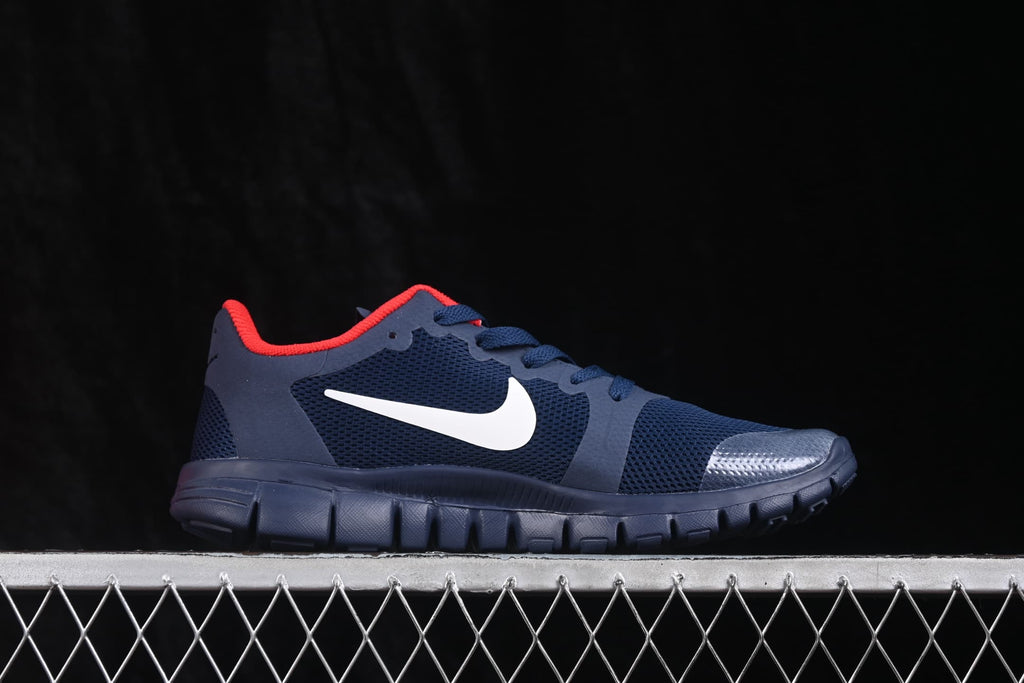 Opposite side profile of the navy Nike Free 3.0 shoe with a white Swoosh and textured toe overlay.