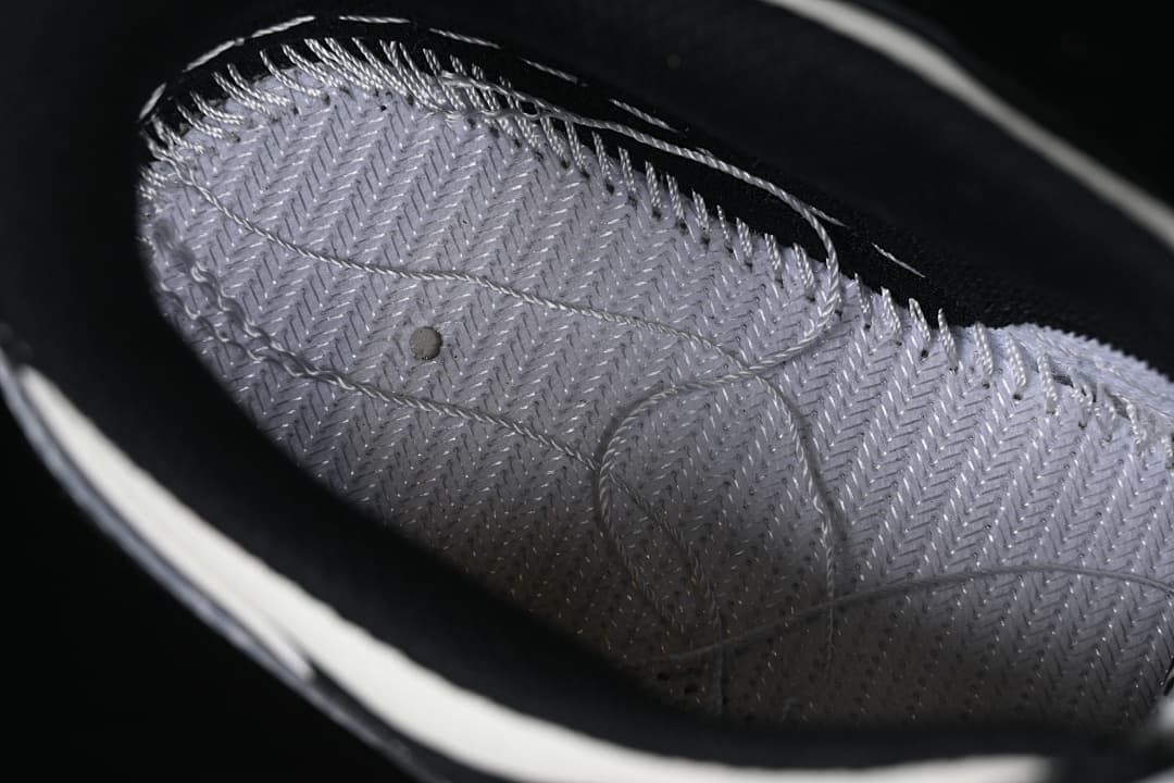 Close-up of the patterned gray shoe interior and stitching.