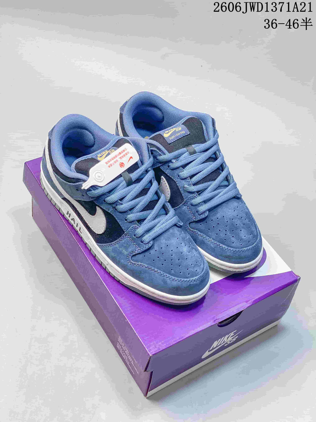 Pair of blue Nike SB Dunk Low Pro sneakers displayed on a purple Nike SB box.