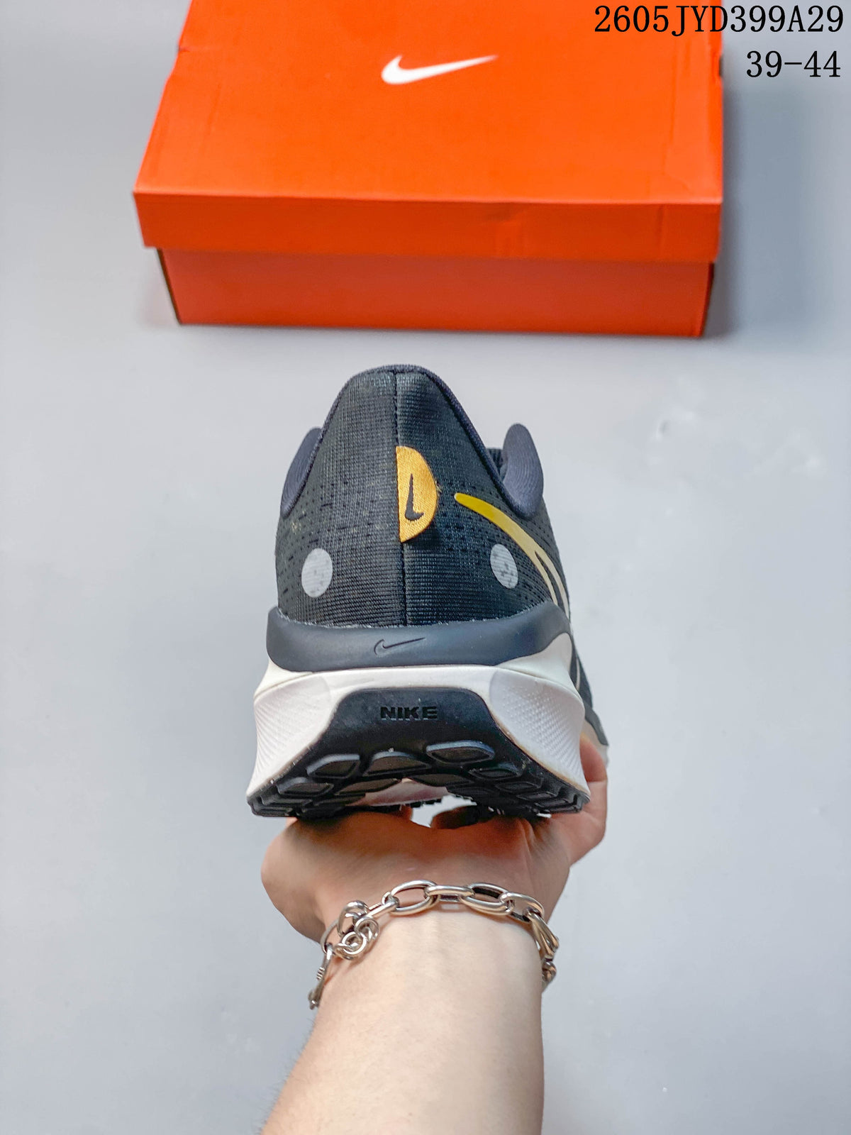 Rear view showing the heel and midsole of a dark gray running shoe.