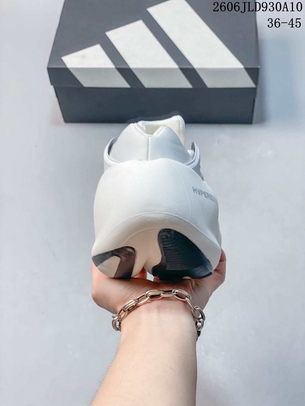 Rear view of the white adidas Hyperboost sneaker with dark outsole accents.