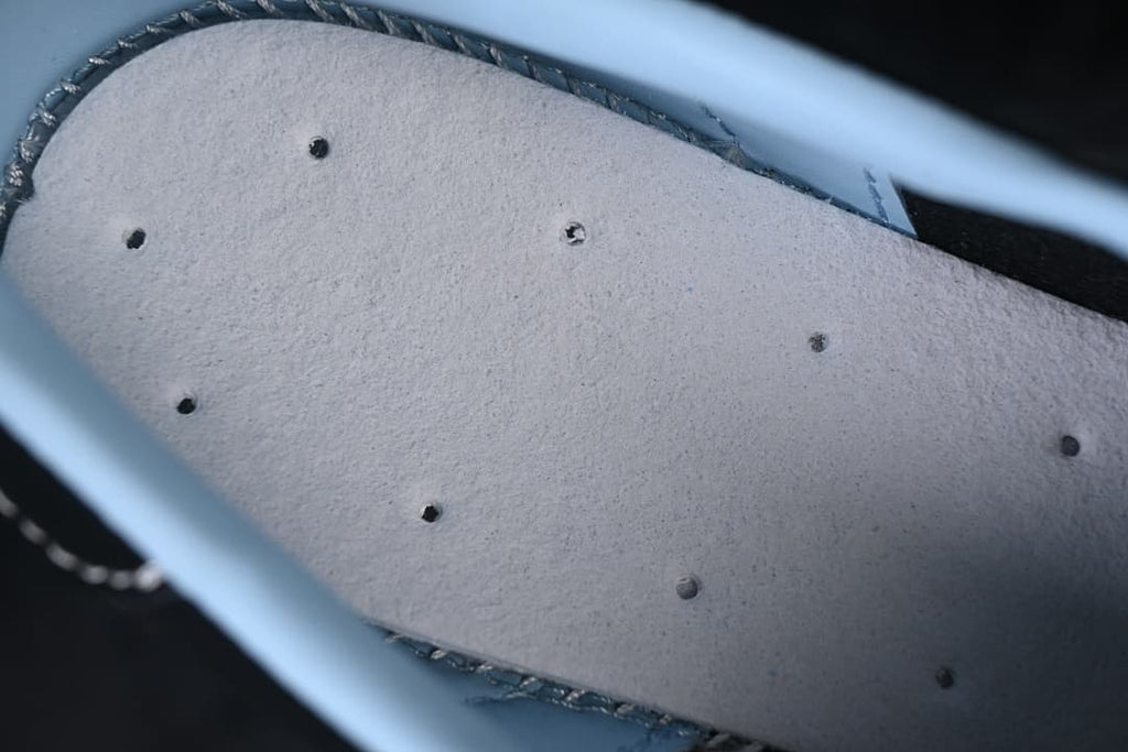 Close-up of the pale-colored underside of the shoe's insole