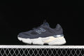 Side view of navy New Balance kids’ sneakers with a light sculpted sole