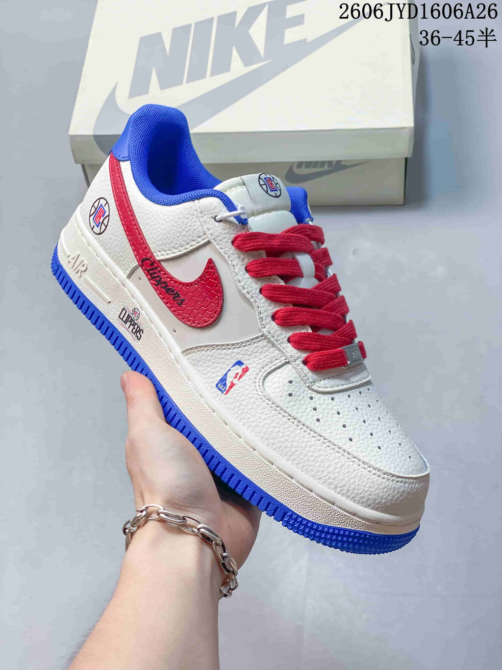 White low-top sneaker with red Swoosh, blue trim and LA Clippers graphics