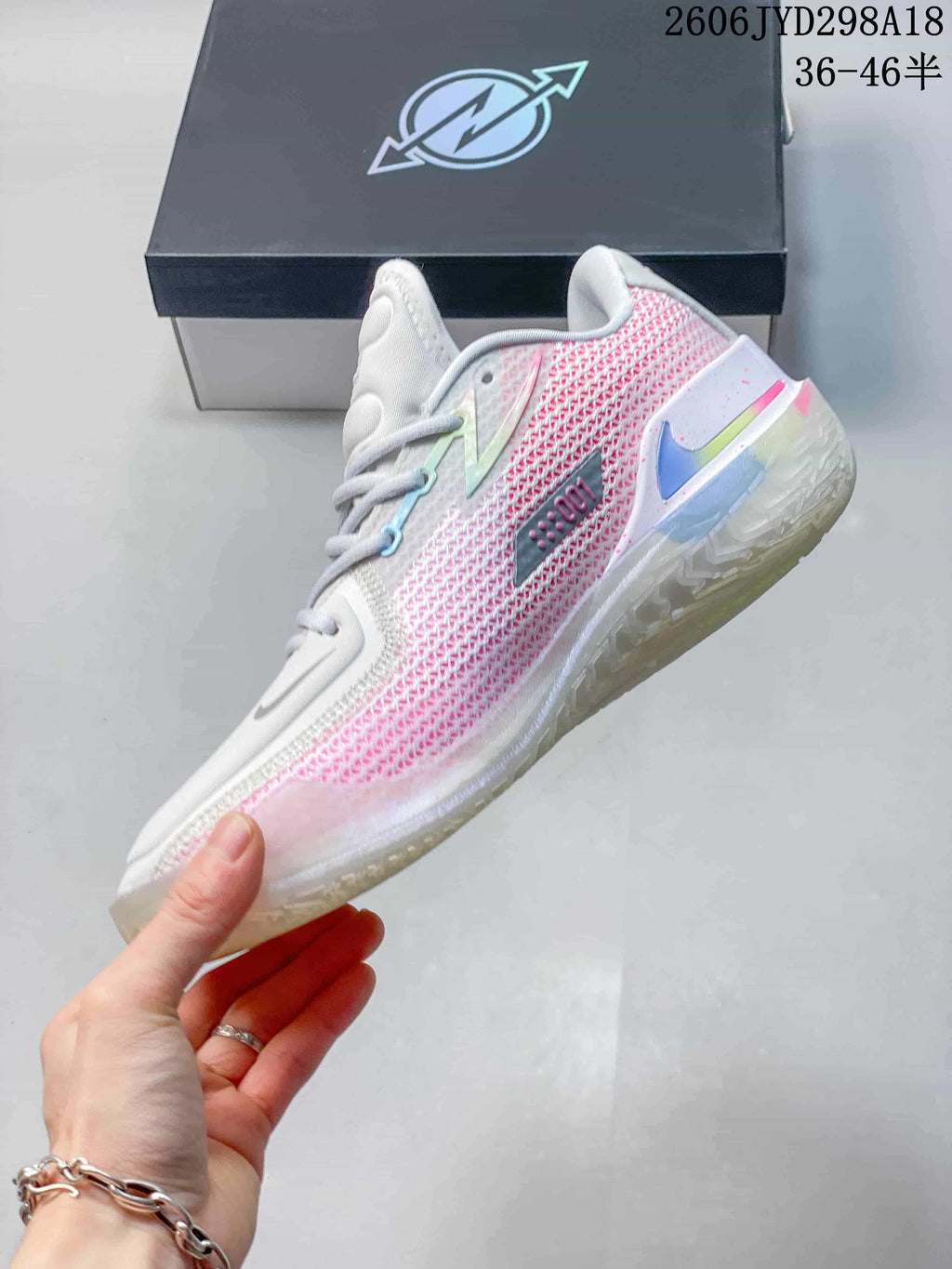 Side view of the white and pink low-top basketball shoe.