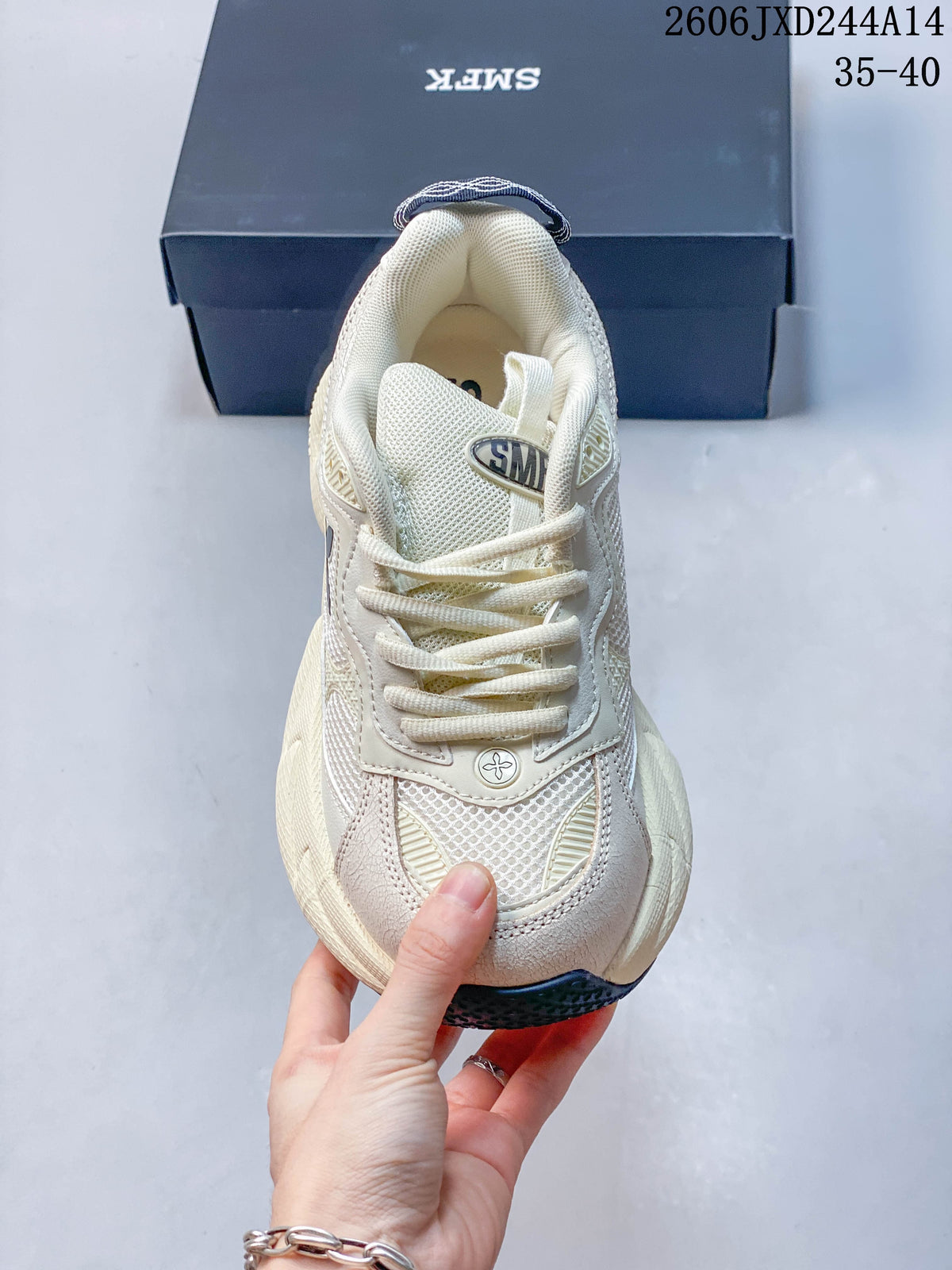 Front view of the sneaker with cream laces, mesh panels, and a rounded toe.