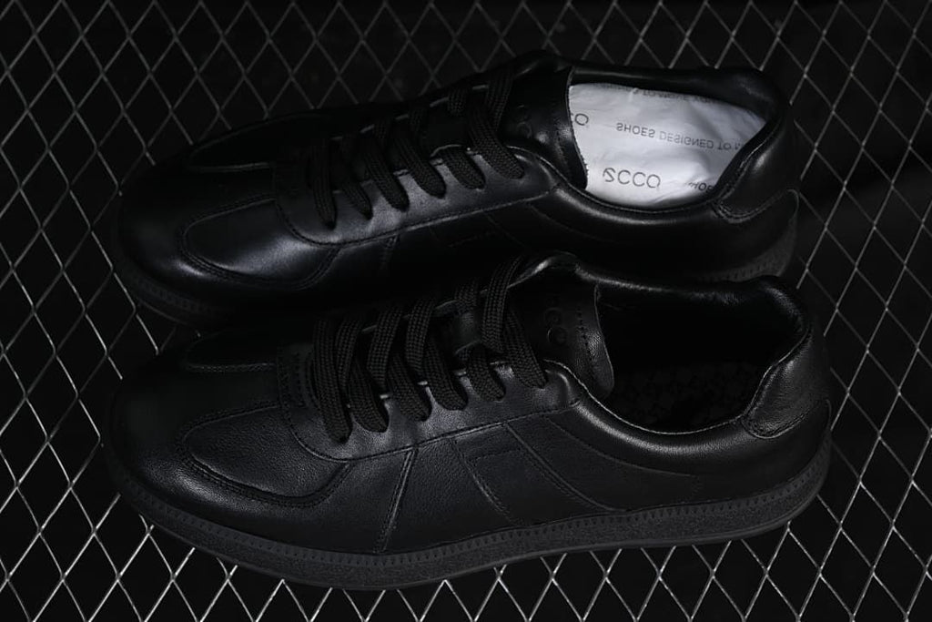 Pair of black low-top lace-up sneakers shown from above