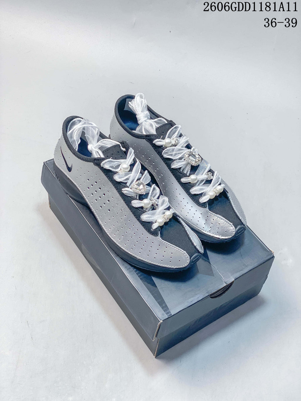 Pair of silver and navy Nike Air Superfly low-top sneakers with white decorative laces.