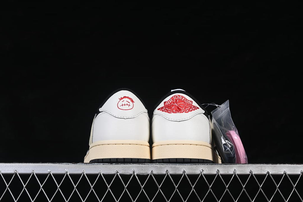 Rear view showing white heel panels with red embroidered graphics and an extra pink lace set.
