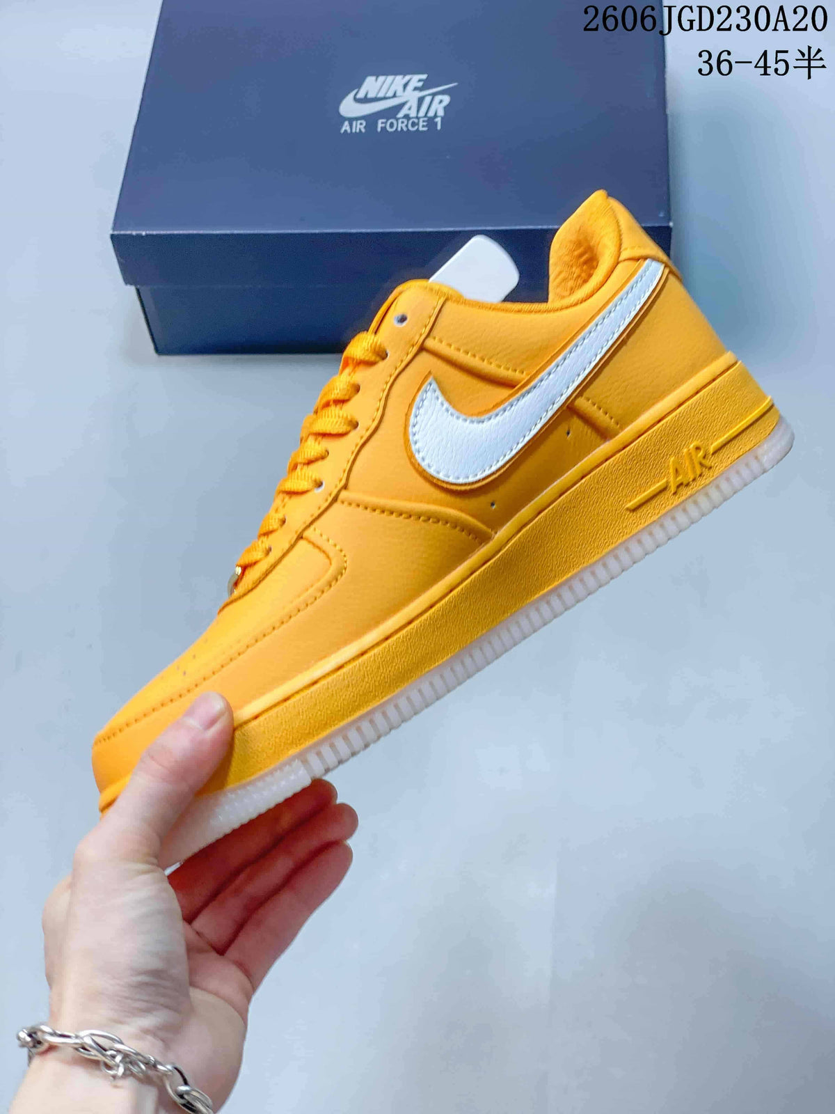 Side view of a yellow Nike Air Force 1 low-top sneaker with a white Swoosh