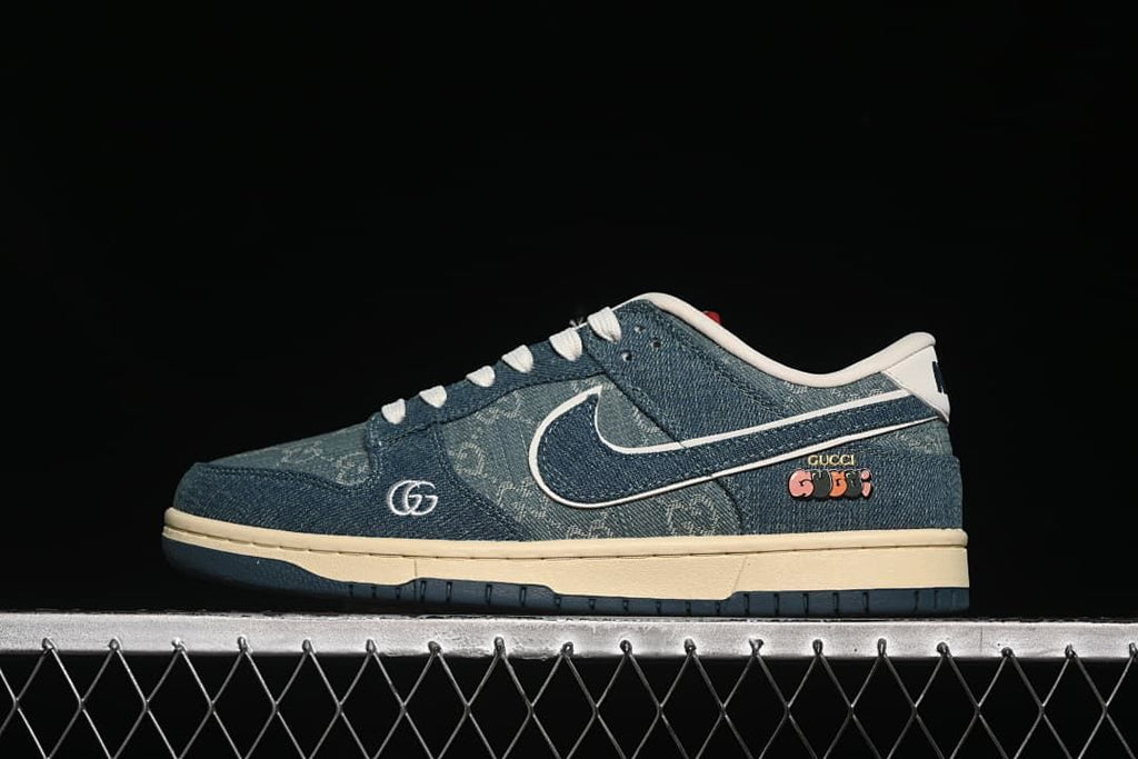 Side profile of a blue denim-look low-top sneaker with white Swoosh