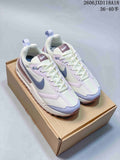 Pair of Nike Air Max Dawn sneakers in cream white, lavender, blue-gray, and mauve, shown on a box.