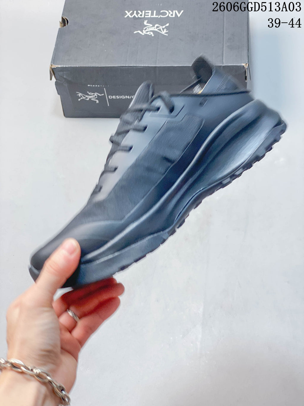 Side profile showing the dark gray upper, laces, and raised sole