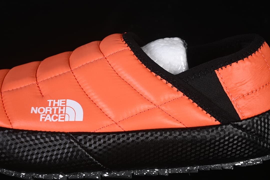 Side detail of the orange quilted upper and black trim