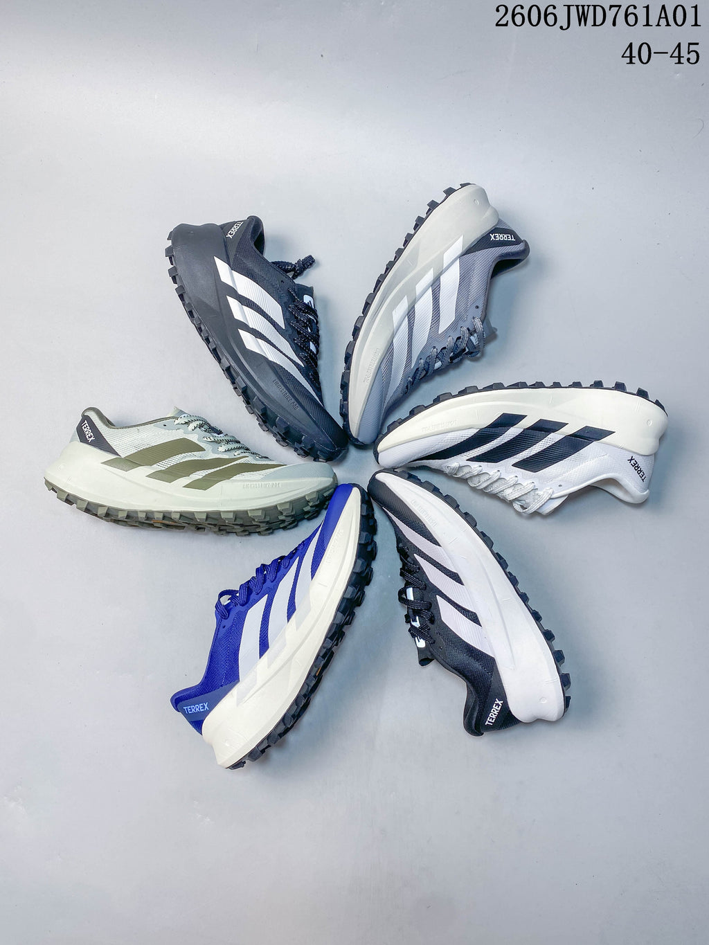 Several Adidas Terrex trail running shoes displayed in different color combinations