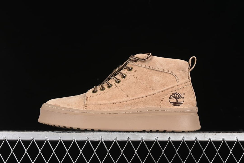 Side view of a sand-colored Timberland mid-top lace-up boot