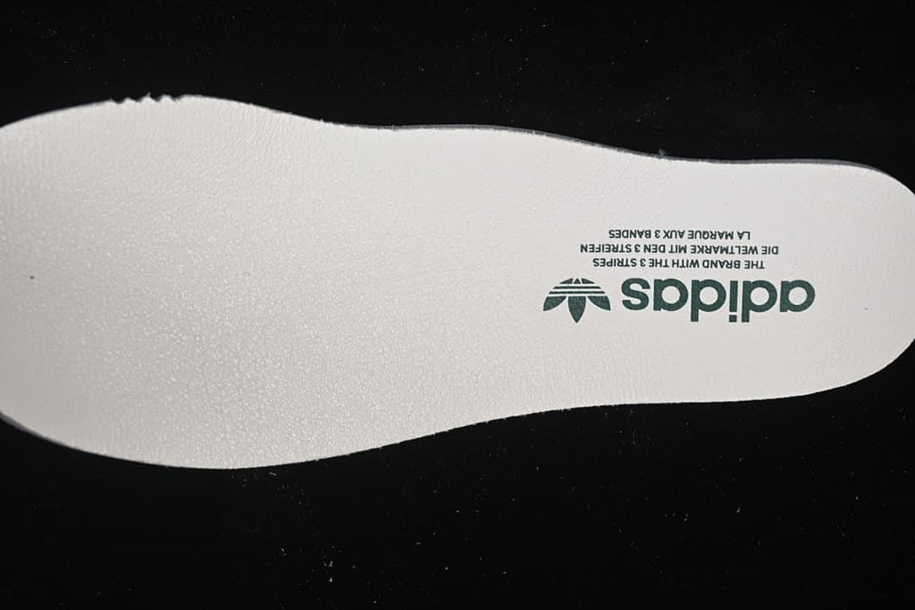 Close-up of an adidas-branded light-colored insole