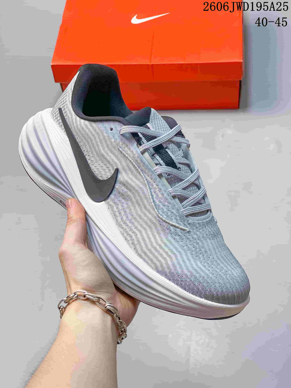 Light gray running shoe with a dark side Swoosh and sculpted pale midsole.