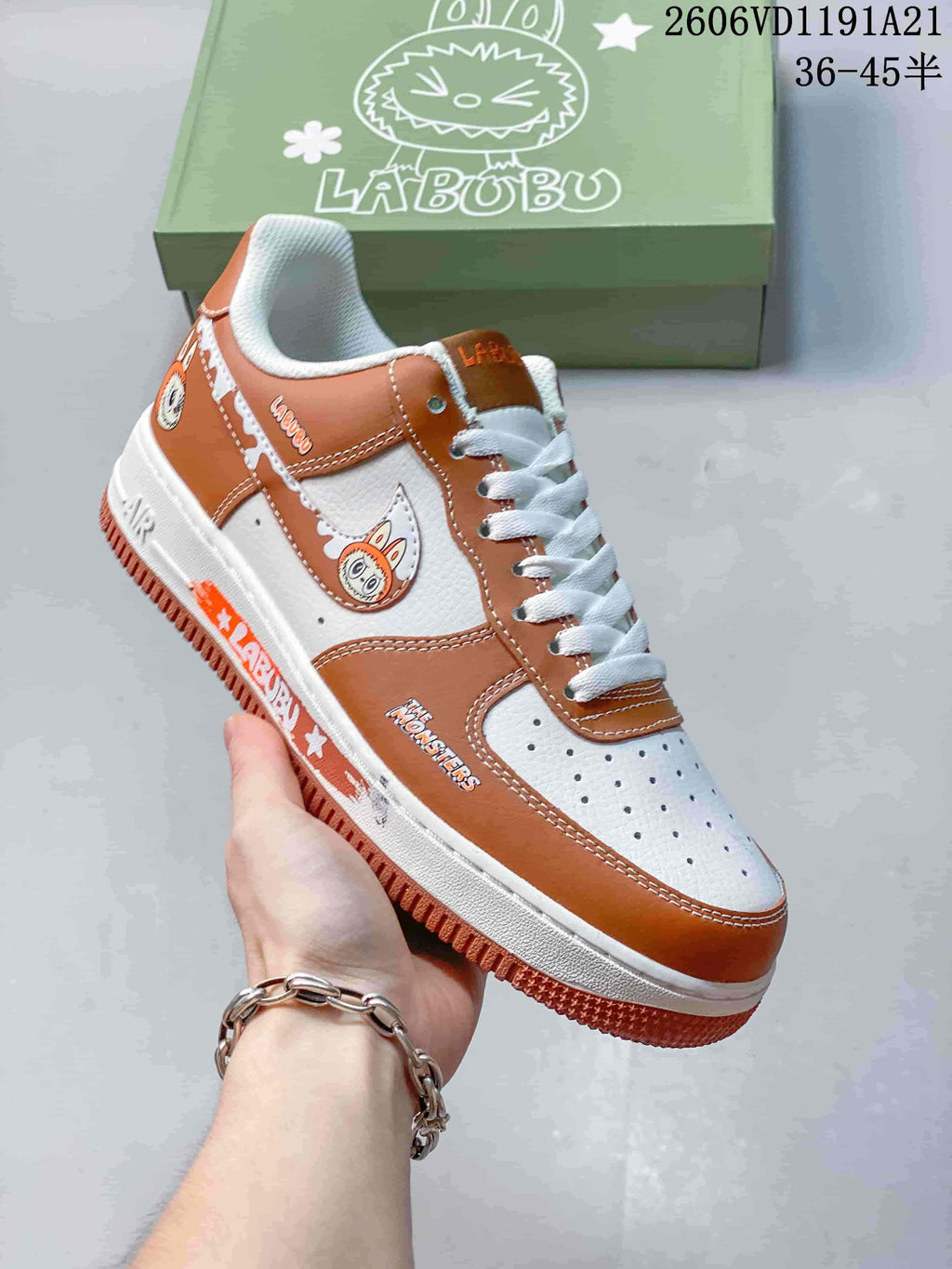 Angled side view of brown-and-white sneaker with character graphics and printed side details