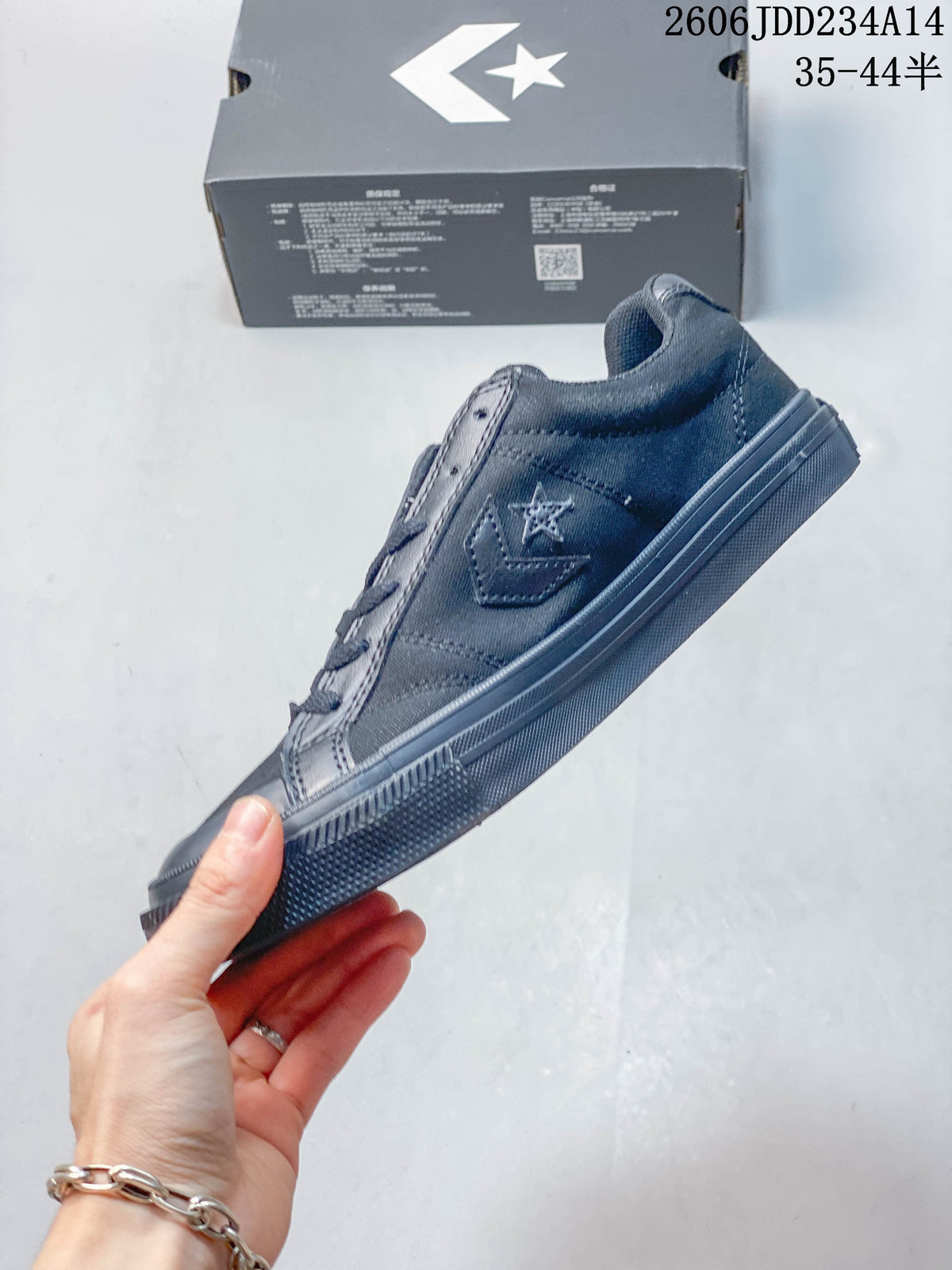 Side view of a charcoal Converse low-top sneaker with tonal emblem