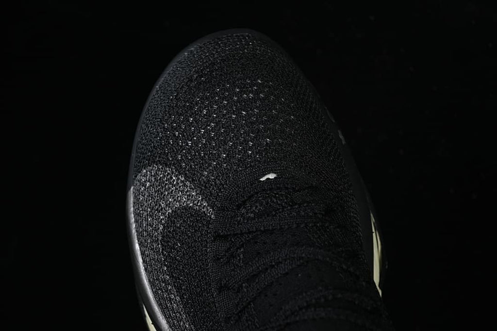 Top view of the black knit toe and lacing