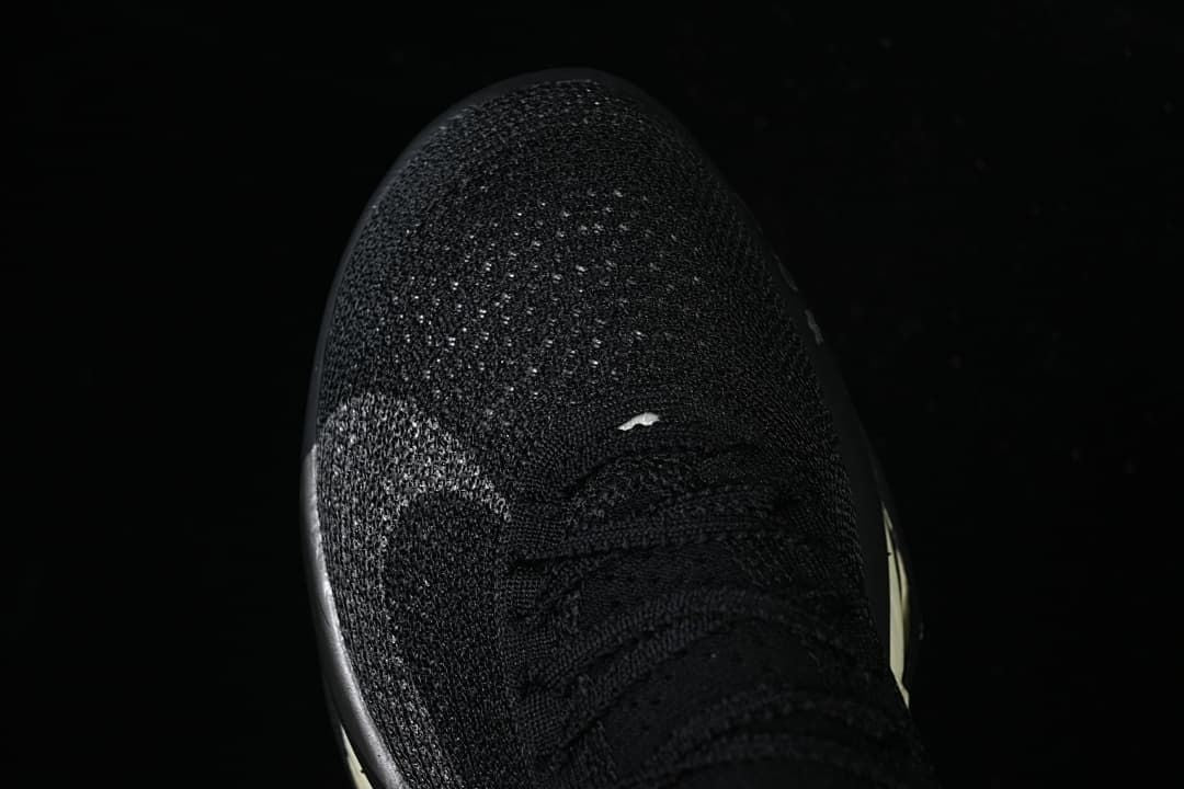 Top view of the black knit toe and lacing