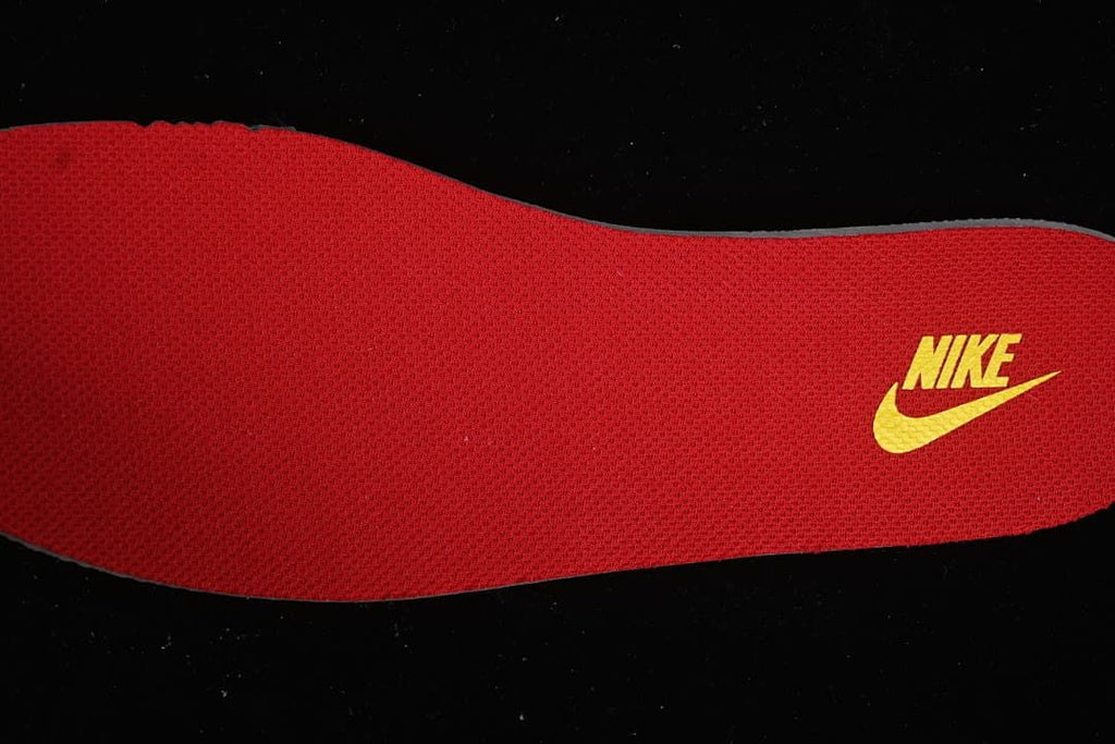 Close-up of a red insole with yellow Nike branding