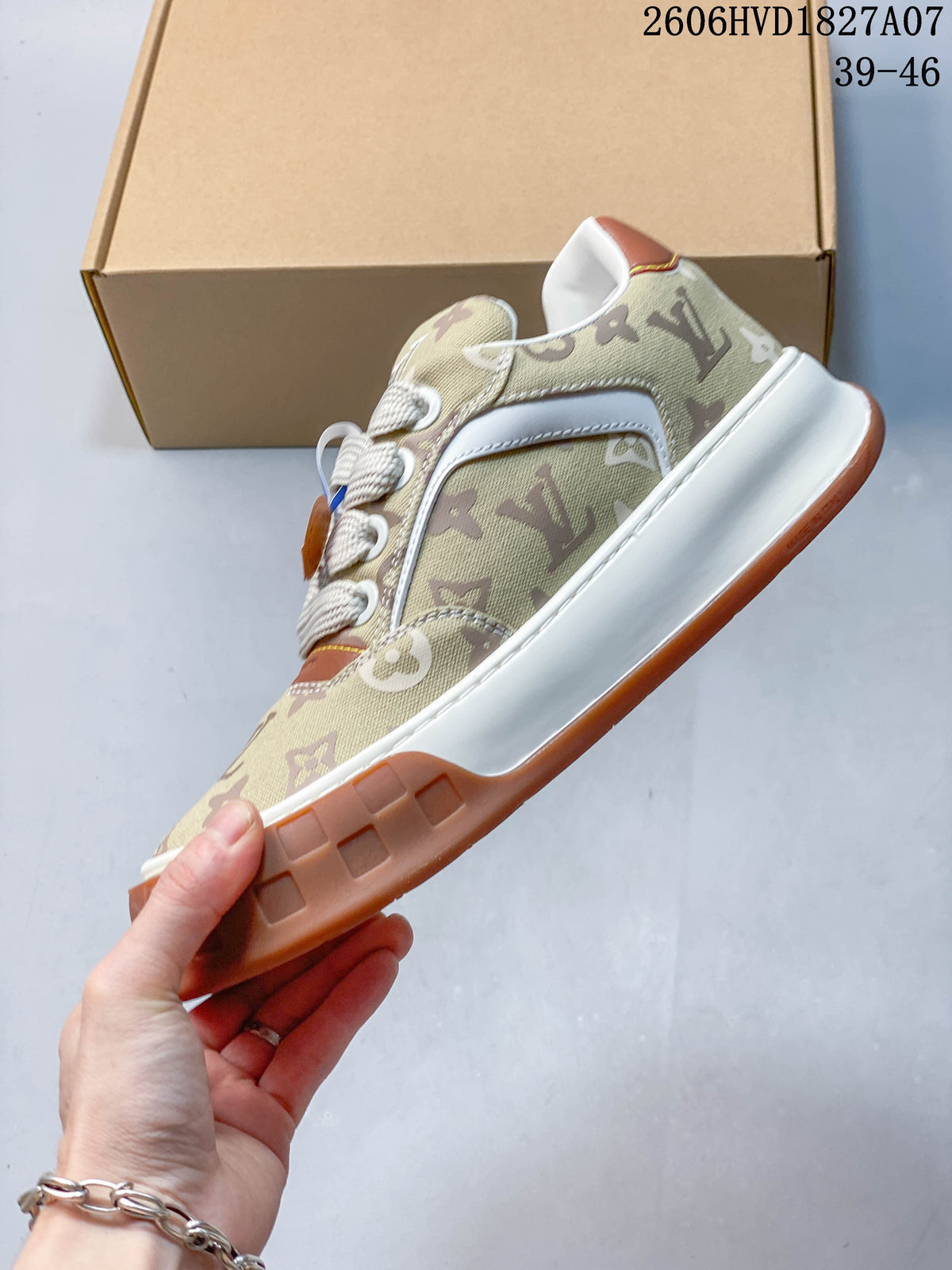 Side view of the beige monogram sneaker with white side panels and a gum-brown outsole.