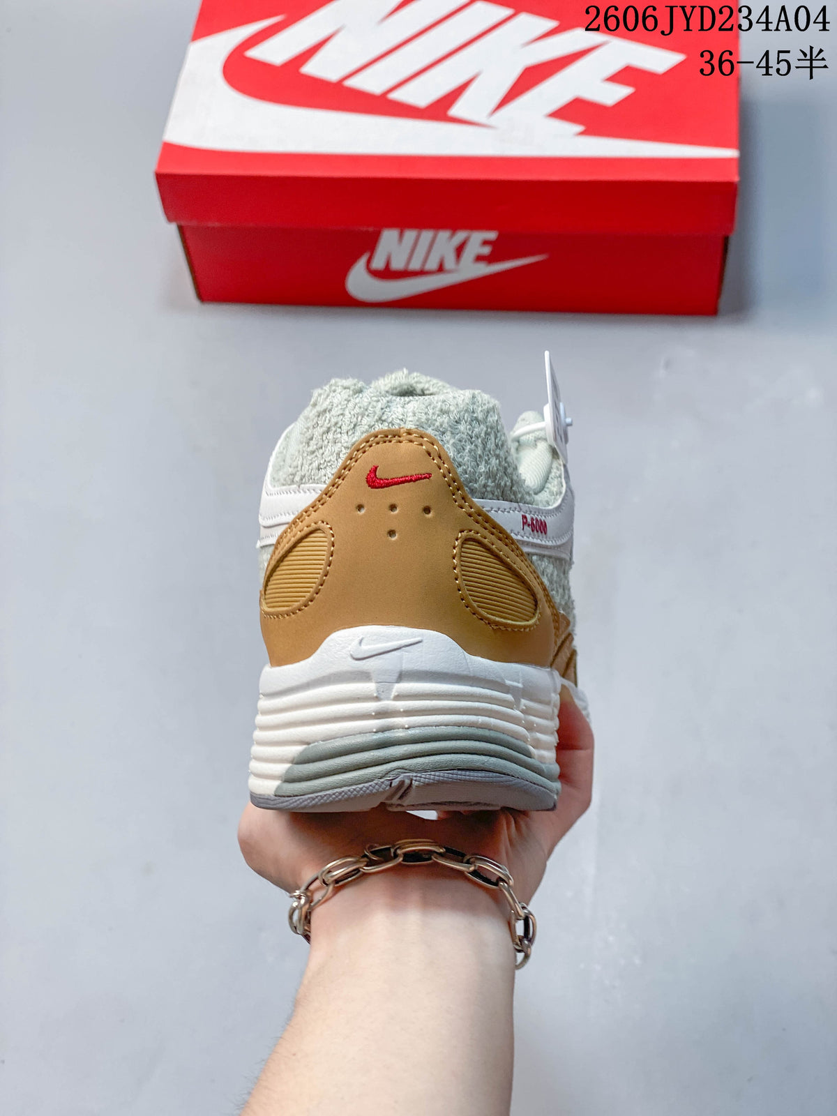 Rear view showing the tan heel panel and layered white midsole of the Nike P-6000.