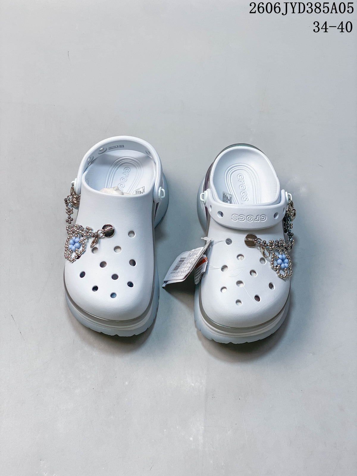 Pair of white platform clogs with decorative charms and adjustable heel straps.