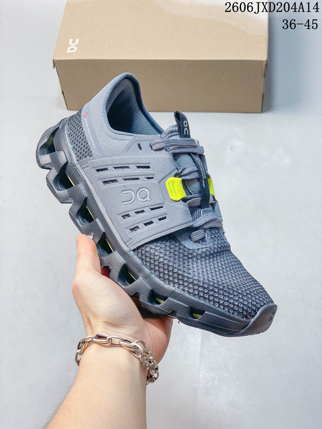 Side view of a gray running shoe with neon yellow accents