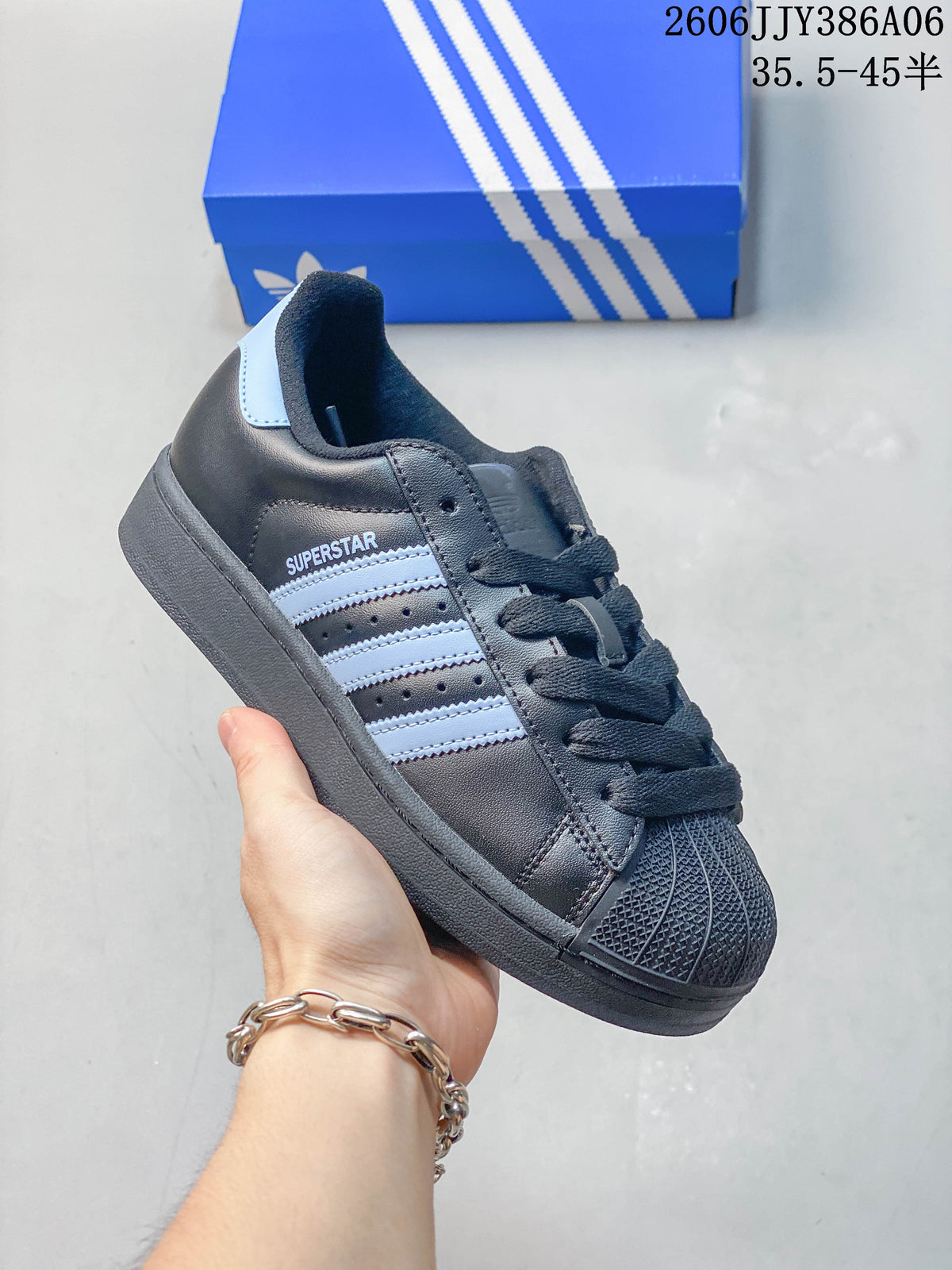 Close side view of the adidas Superstar 2 with charcoal upper and pale blue stripes