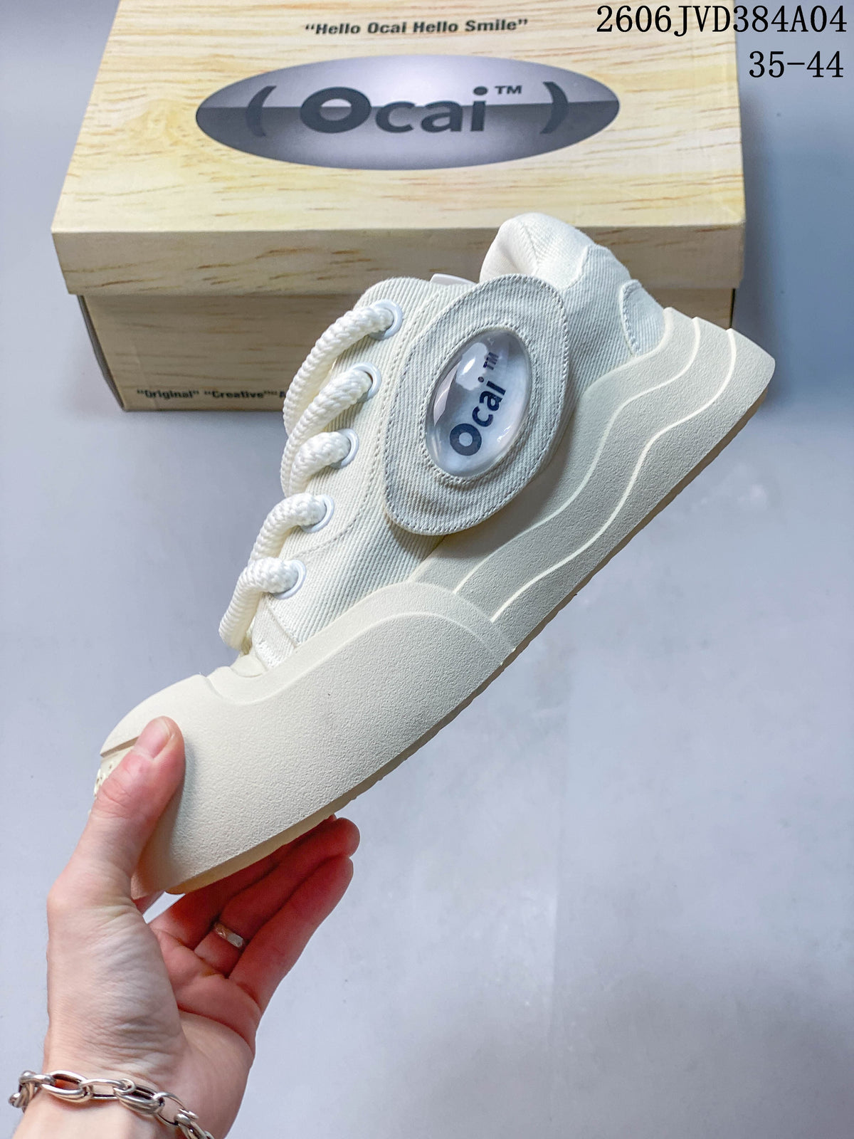 Side profile of a cream Ocai sneaker with oval side detail and chunky sole