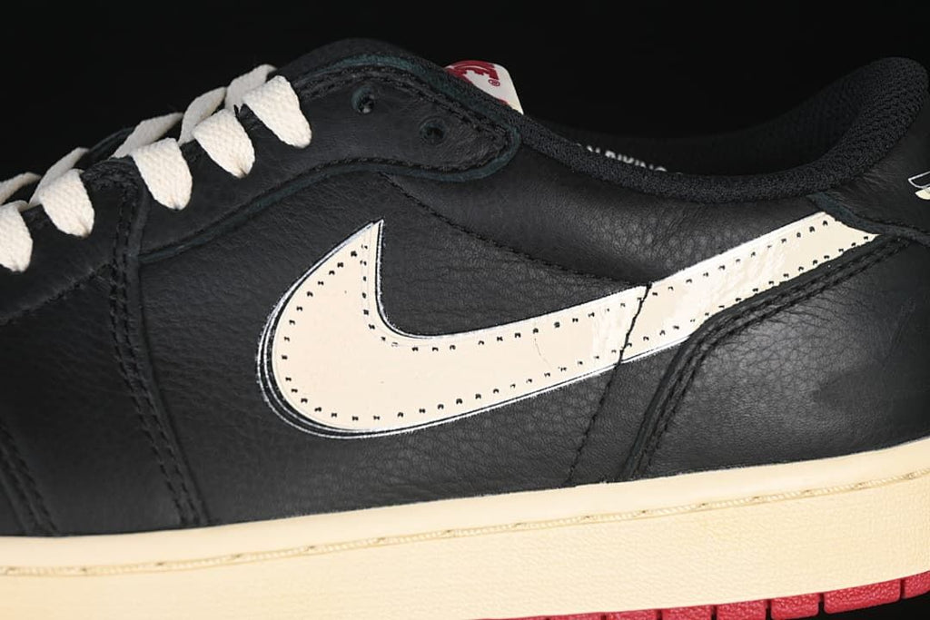 Close-up of the side Swoosh, black upper and sail-colored midsole