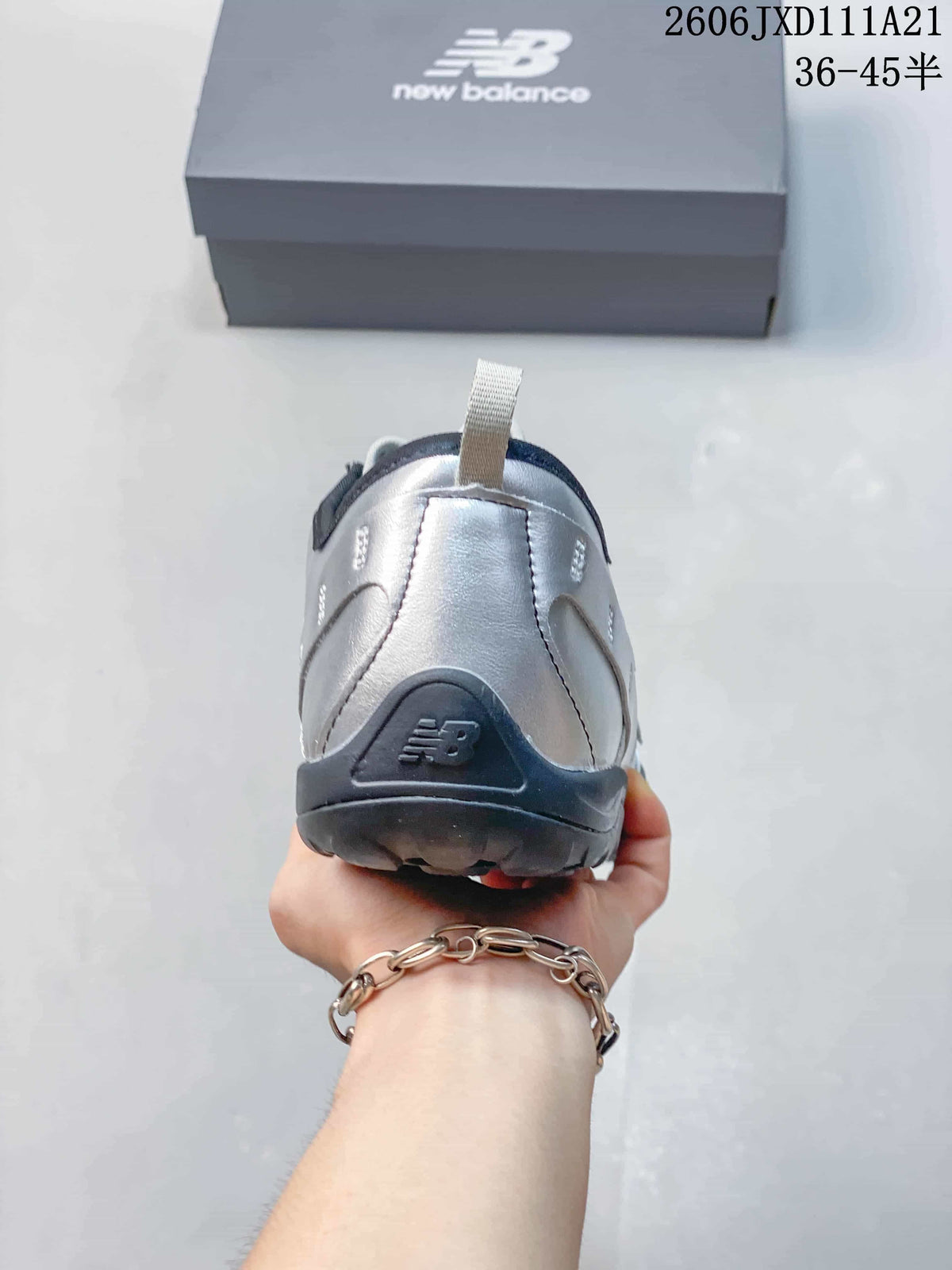 Rear view of the silver-toned sneaker with dark heel detail