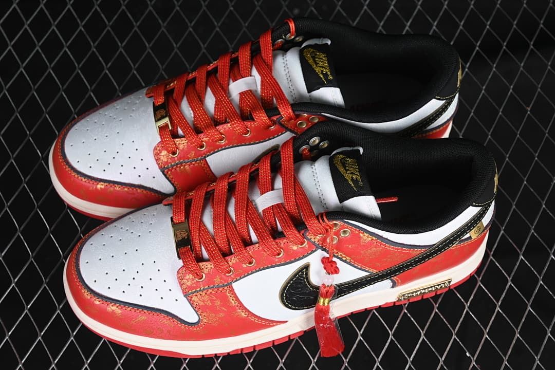 Pair of red, white, and black low-top sneakers shown from above