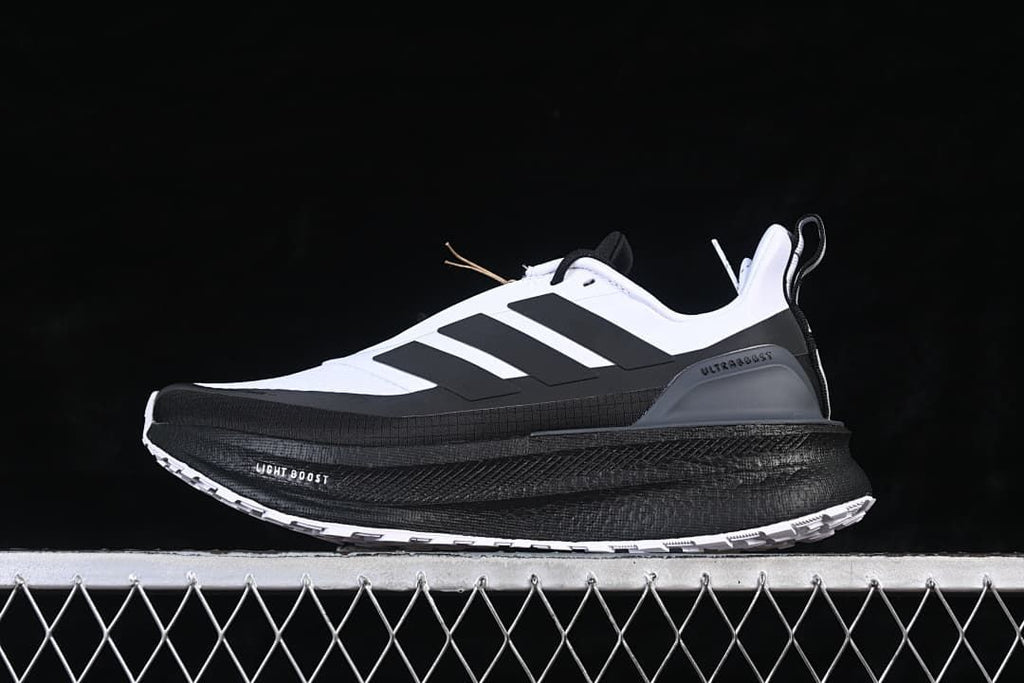Side view of white and black Adidas Ultraboost 5 Climawarm running shoe
