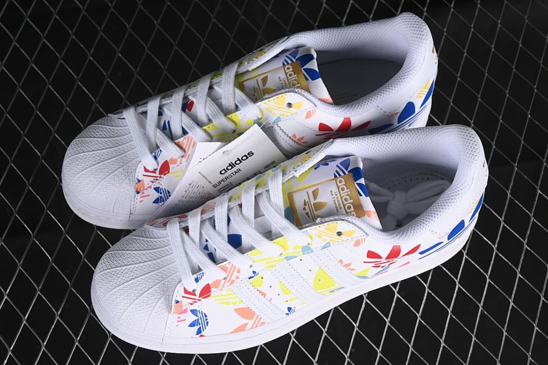 Pair of white multicolor adidas Superstar sneakers viewed from above